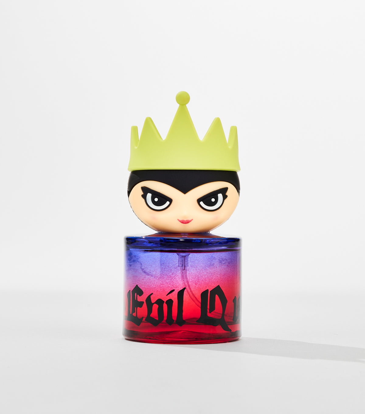 A round perfume bottle with a purple-to-red gradient and black gothic lettering has a cartoon queen head cap wearing a lime green crown.