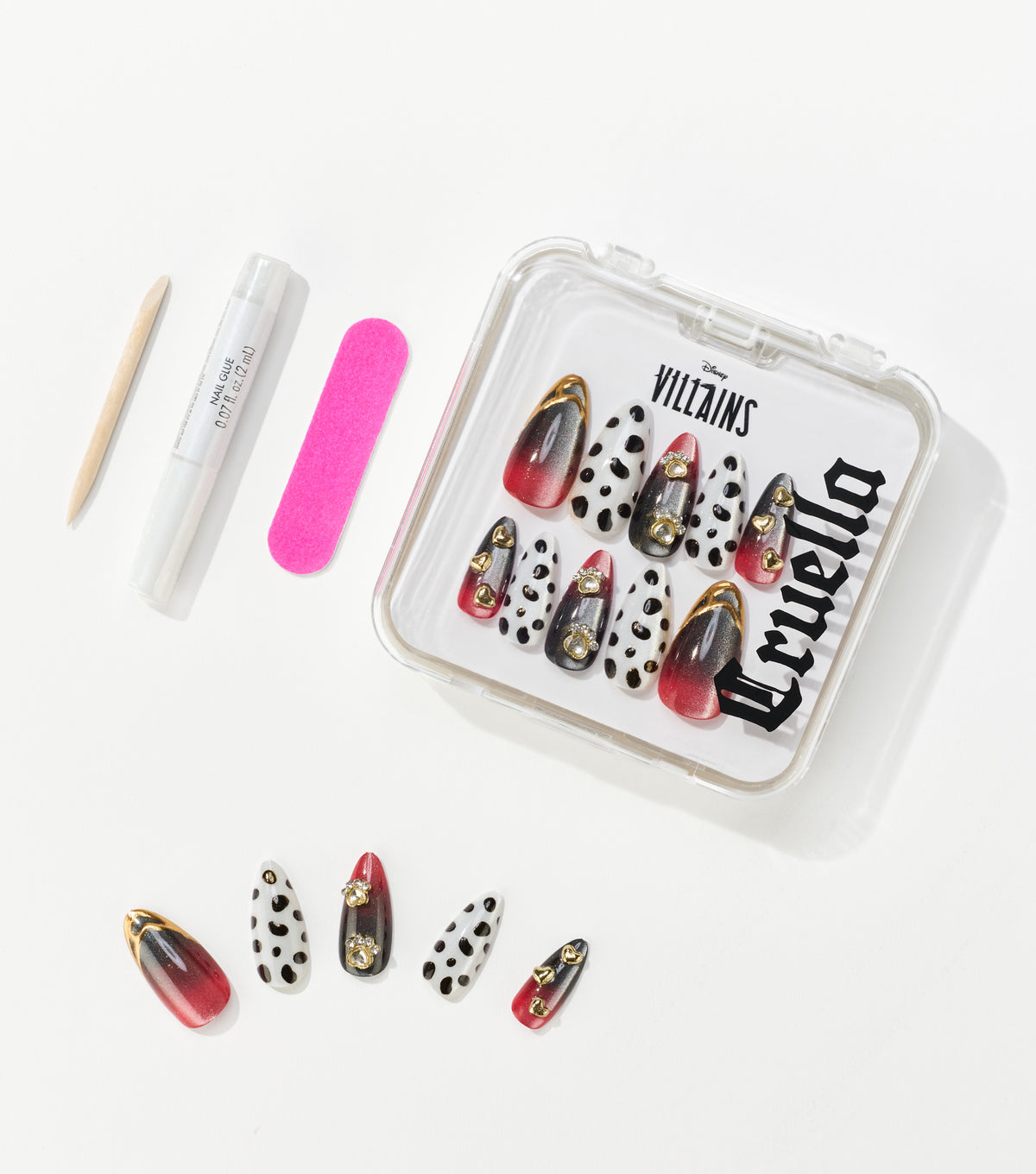 Press-on nails with red-to-black gradients and black spots on white sit in a clear case beside glue, a file, and a stick.
