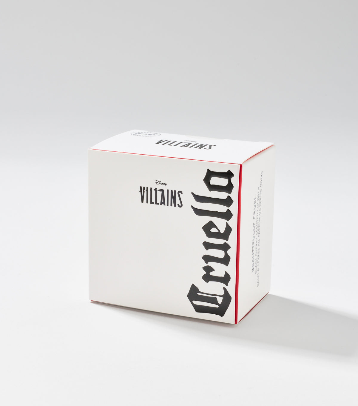 A white square product box with red edges displays Disney Villains branding and the name Cruella in large black gothic lettering.