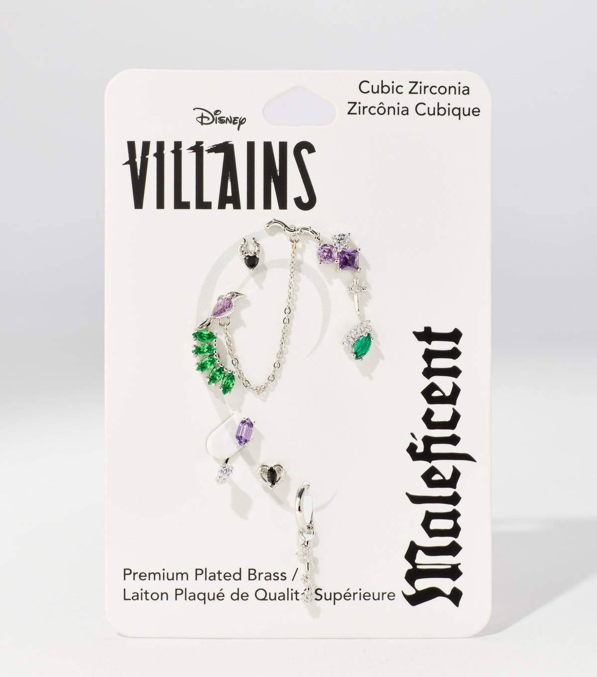 A white Disney Villains Maleficent backing card holds silver earrings and an ear cuff set with green, purple, and black stones.