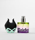A round glass perfume bottle with a green-to-purple gradient and silver spray nozzle stands beside its horned, green-faced character cap.