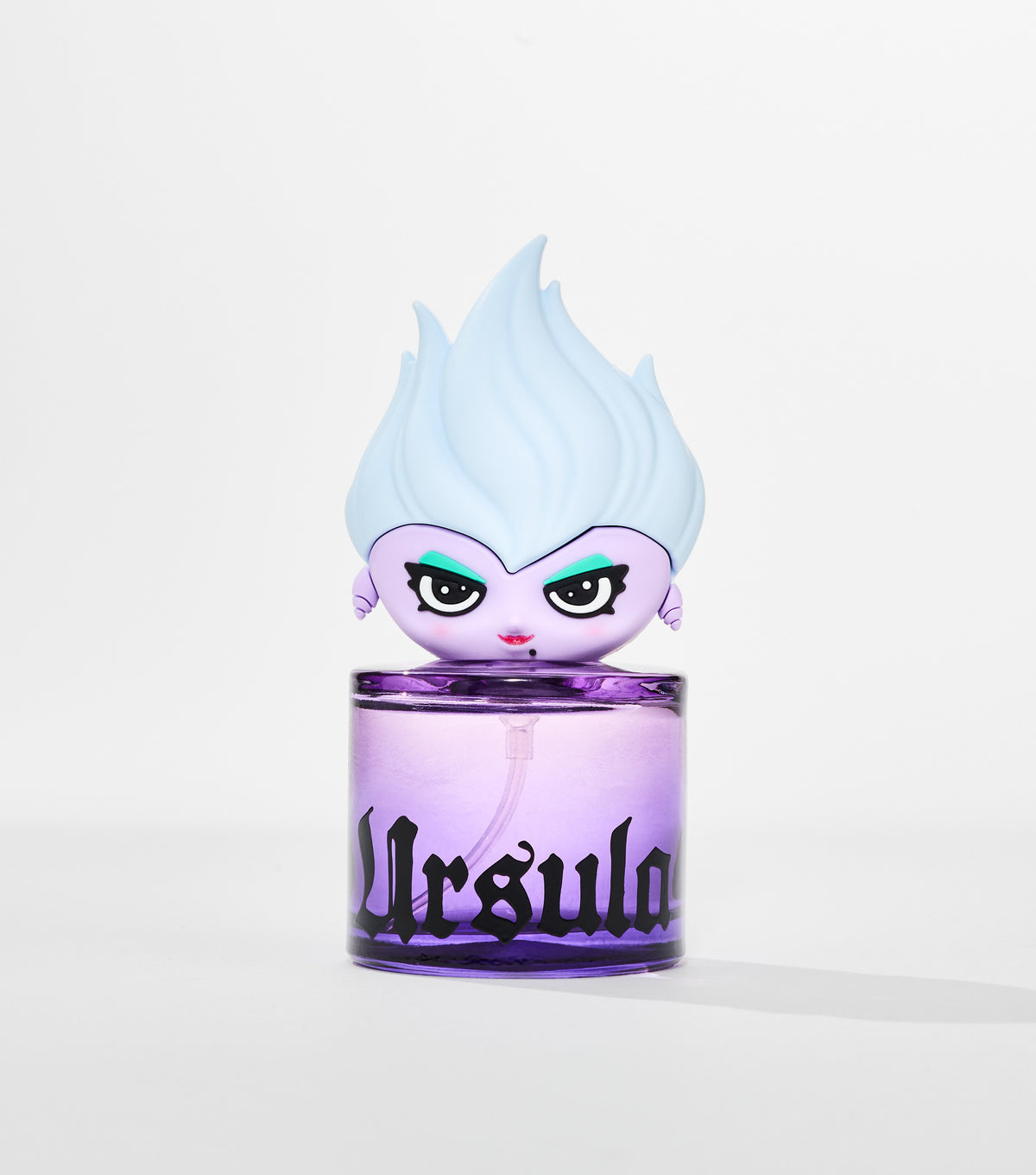 A round purple glass perfume bottle with black gothic lettering, topped by a cartoon figure with pale blue flame-like hair.