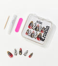 Press-on nails with red-to-black gradients and black spots on white sit in a clear case beside glue, a file, and a stick.