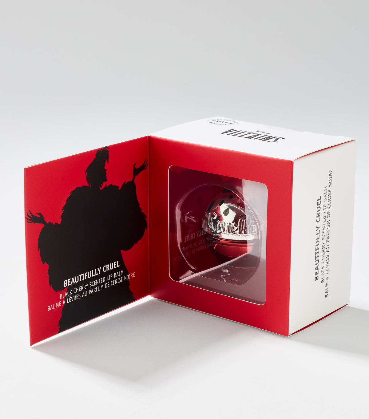 A red and white gift box opens to show a round, glossy red lip balm and a black silhouette of a fur-coated figure.