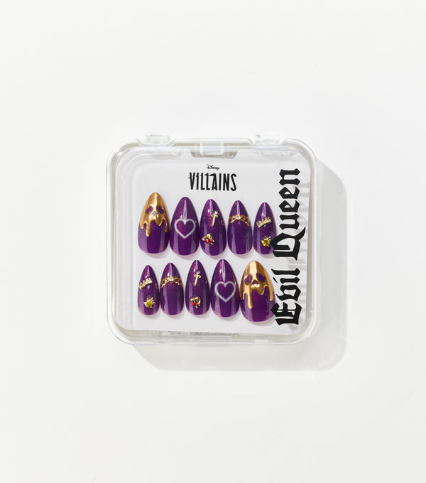 Clear case holding ten purple almond-shaped press-on nails with gold drip tips, heart outlines, and small jeweled charms, labeled Disney Villains Evil Queen.