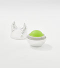An open spherical lip balm with a green dome inside a white base, beside a silver horned lid.