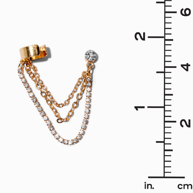 Clous d&#39;oreilles reli&eacute;s par un ornement en strass couleur dor&eacute;e,