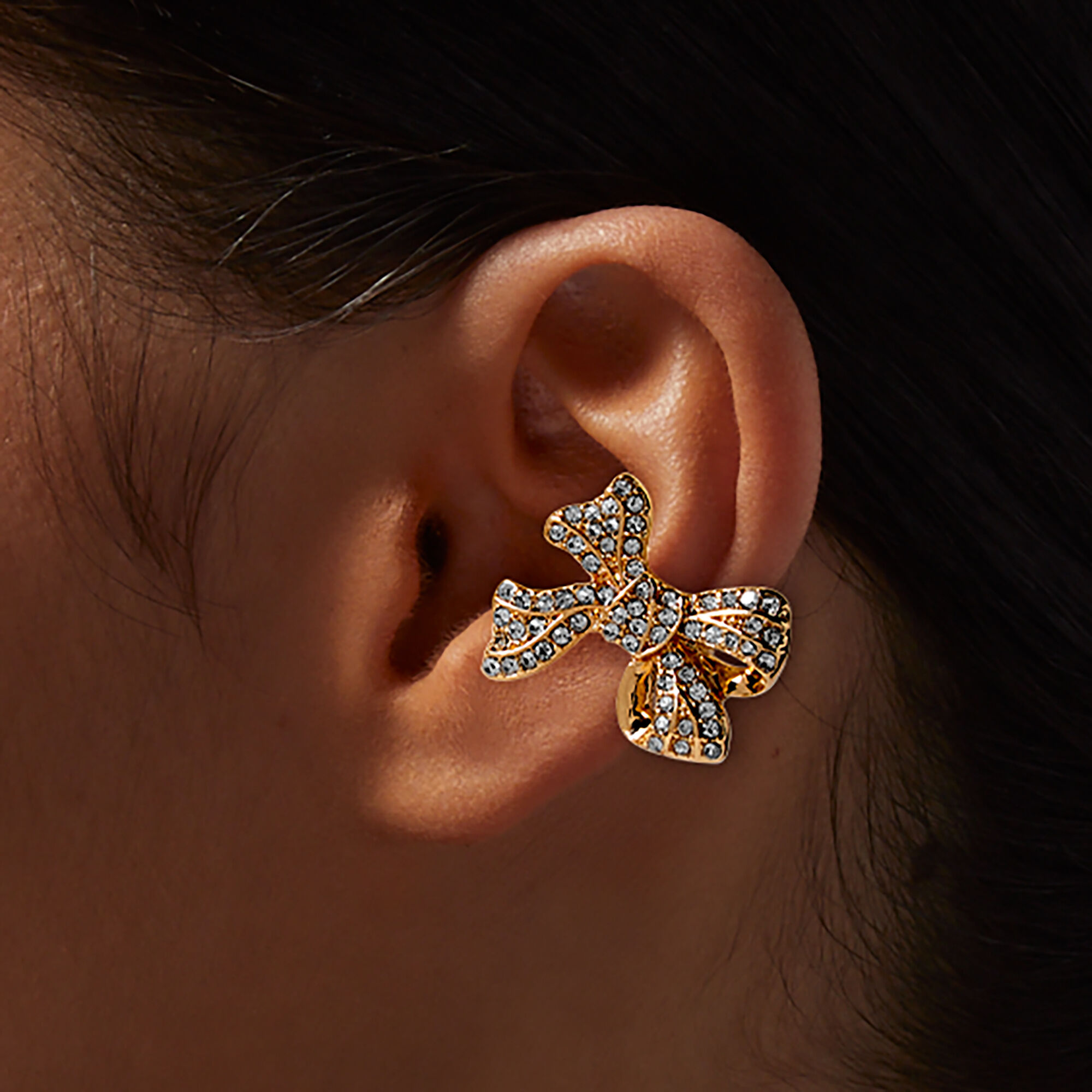 Manchette d'oreille nœud pavé strass couleur dorée,