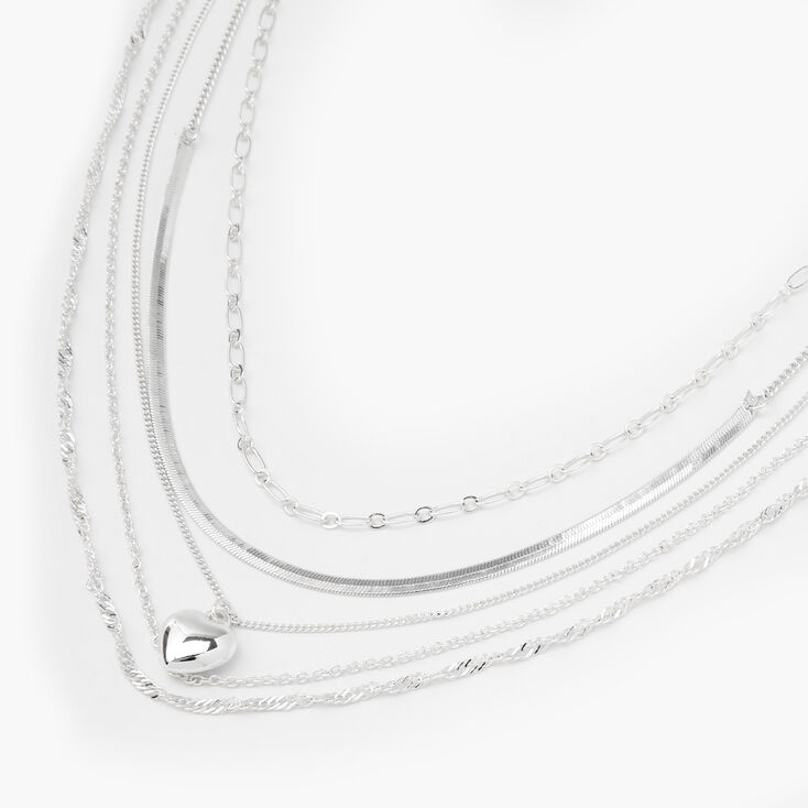 Claire's Collier multi-rangs aux designs variés avec chaînes et cœur bouffant couleur argentée
