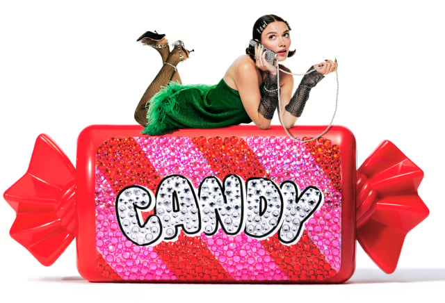 Image of a model sitting on a wrapped, glittery candy