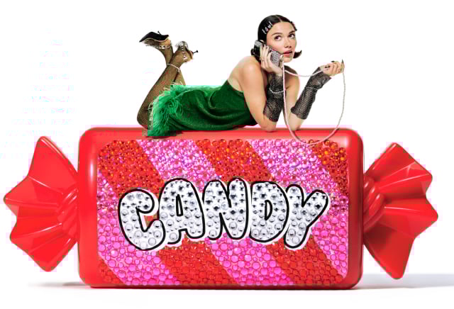 Image of a model sitting on a wrapped, glittery candy